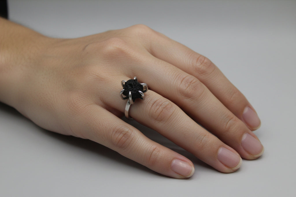 Silver ring with a black gemstone on a white background Re.Spirit