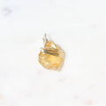 Gold pendant on a white background